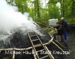 Anzünden des Holzkohlenmeilers